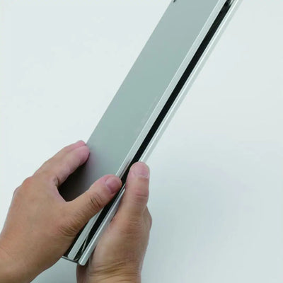Hands holding a silver Soto Field Hopper Mini Pop-up Aluminium Table ready for outdoor fun