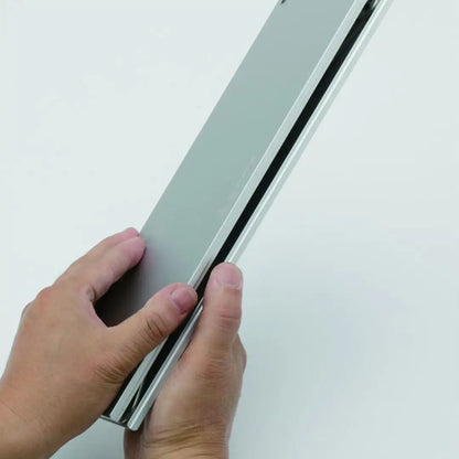 Hands holding a silver Soto Field Hopper Mini Pop-up Aluminium Table ready for outdoor fun