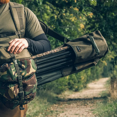 Person wearing Speero Compact Rod Sling with tactical backpack and rifle case