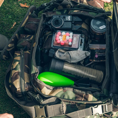 Camouflage-patterned Speero XL Carryall barrow bag packed with outdoor gear