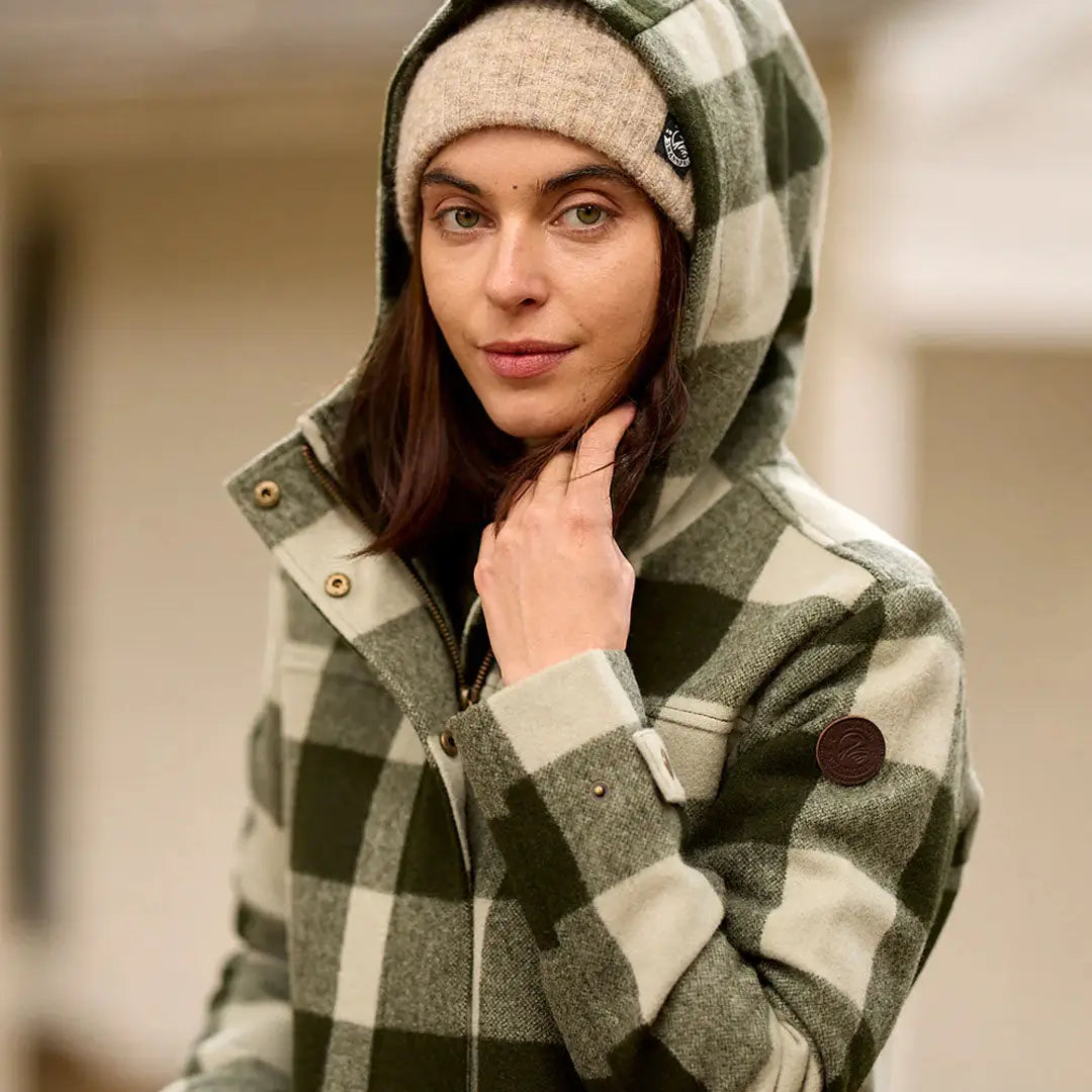 Woman in Swanndri Annmore merino wool overcoat with plaid flannel jacket and beanie