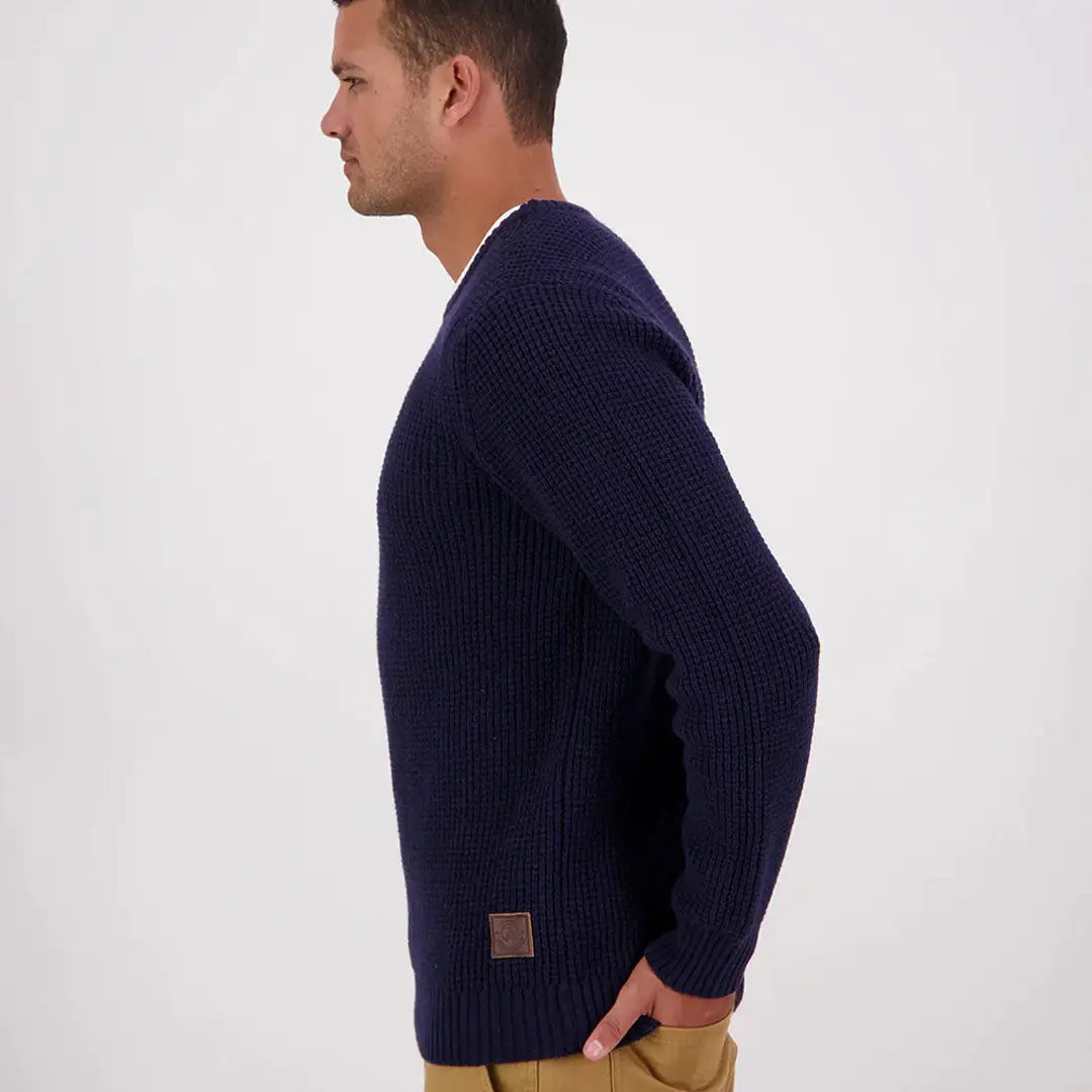 Man modeling navy blue Swanndri Fistral Waffle Knit sweater with brown brand patch
