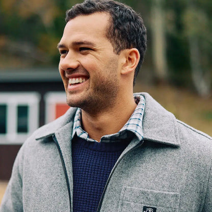 Man wearing Swanndri Fistral Waffle Knit zip-up jacket over blue sweater and plaid shirt