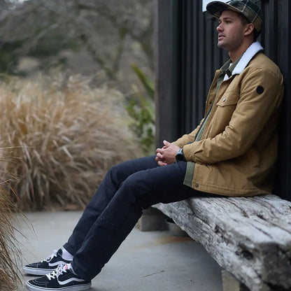 Man wearing Swanndri Kaituna Mens Canvas Jacket, black Vans, plaid cap, stylish look