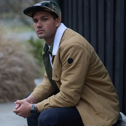 Man wearing plaid cap and tan Kaituna Mens Canvas Jacket with watch