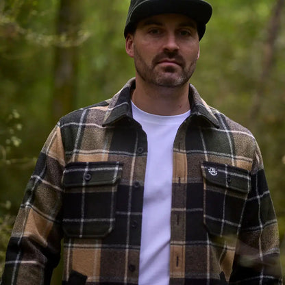 Man in plaid flannel shirt and baseball cap wearing Swanndri Kiaraki V3 Wool Shacket