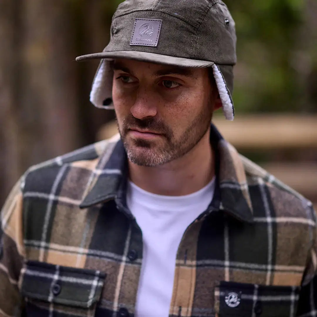 Man wearing Swanndri Kiaraki v3 Wool Shacket with plaid flannel shirt and cap
