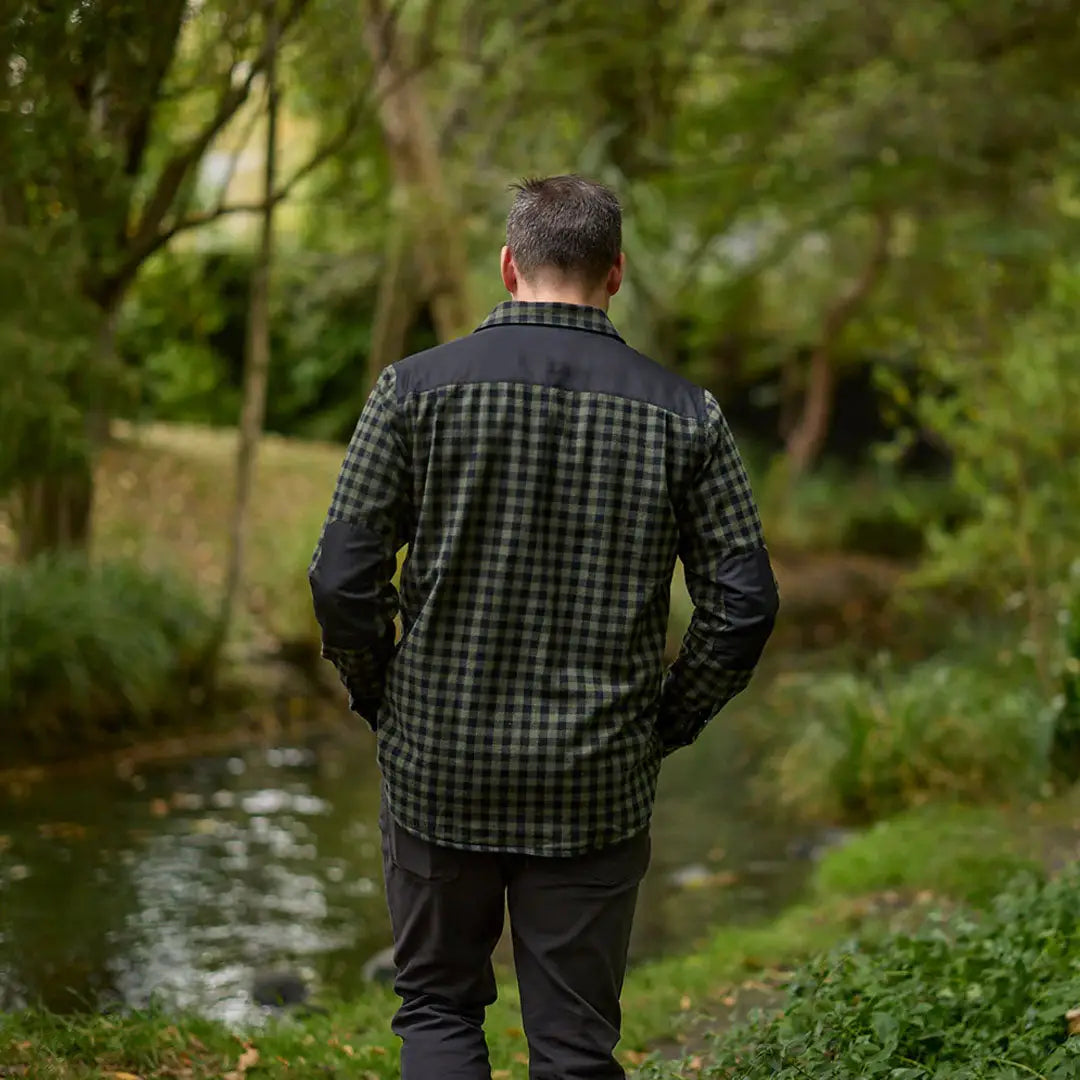 Man in a plaid Swanndri Marton Stormshield LS Shirt with dark shoulders and sleeves
