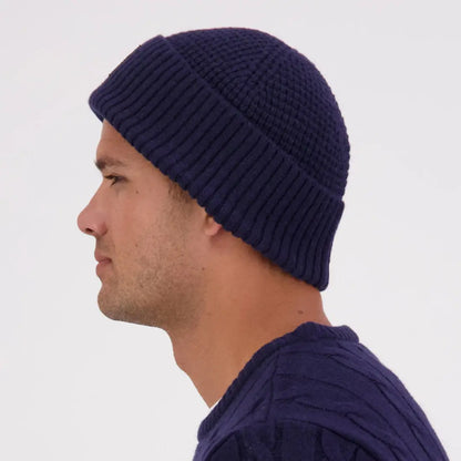 Man wearing navy Swanndri Newton Beanie and matching cable-knit sweater