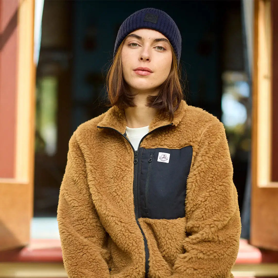 Person wearing Swanndri Newton Beanie and brown sherpa fleece jacket outdoors