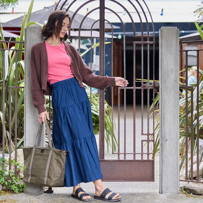 Woman with swanndri queenstown tote bag in stylish brown cardigan and pink top
