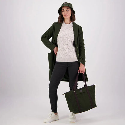 Woman in dark green coat and bucket hat holding Swanndri Queenstown Wool Tote Bag