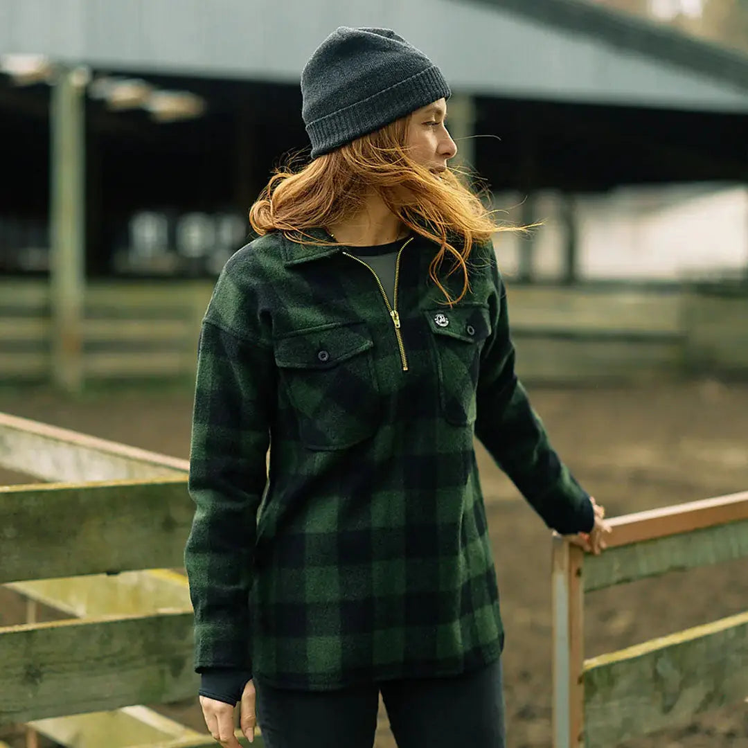 Woman wearing Swanndri Ranger Womens bush shirt with plaid flannel and beanie