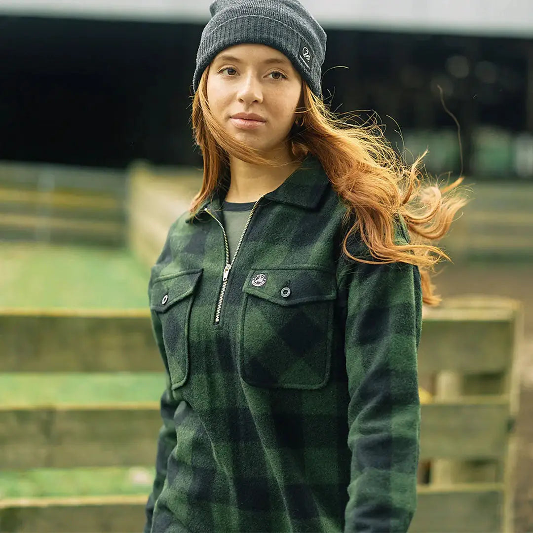 Woman wearing Swanndri Ranger Womens bush shirt in dark green plaid fleece pullover