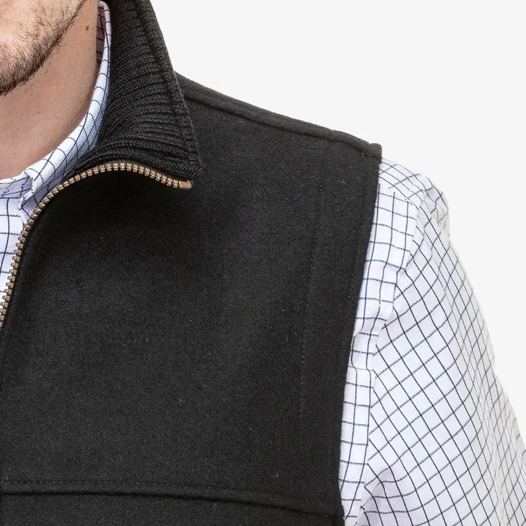 Black Swanndri Saddleback Vest with ribbed collar over white checkered shirt for country clothing outdoors