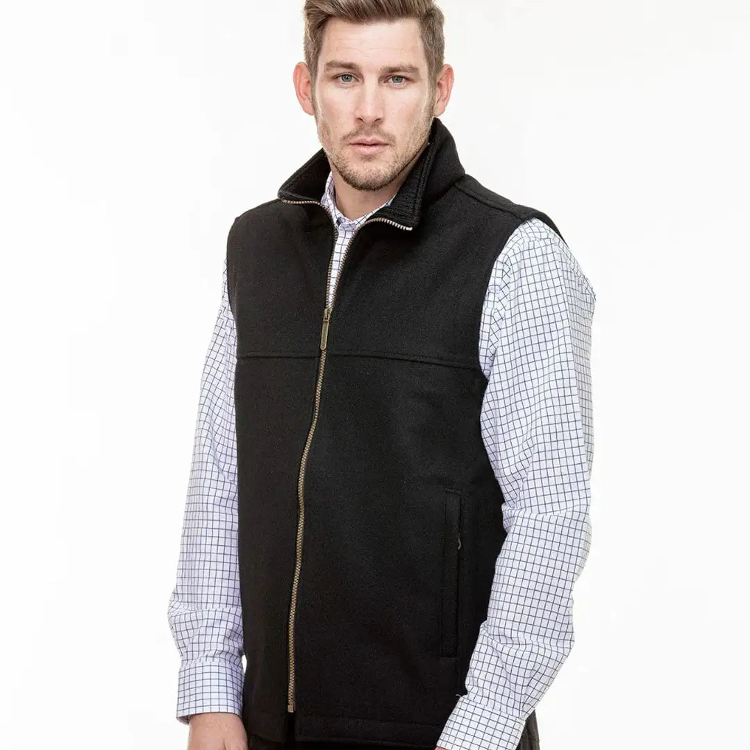 Men’s black fleece vest with full zipper over checked shirt, perfect for country clothing outdoors