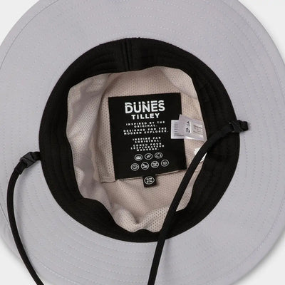 Beige and black Dunes Explorer Hat with DUNES TILLEY label for stylish adventure vibes