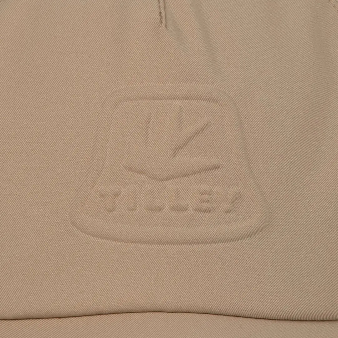 Beige fabric with embossed logo on Tilley Tech Travel Cap for stylish adventures