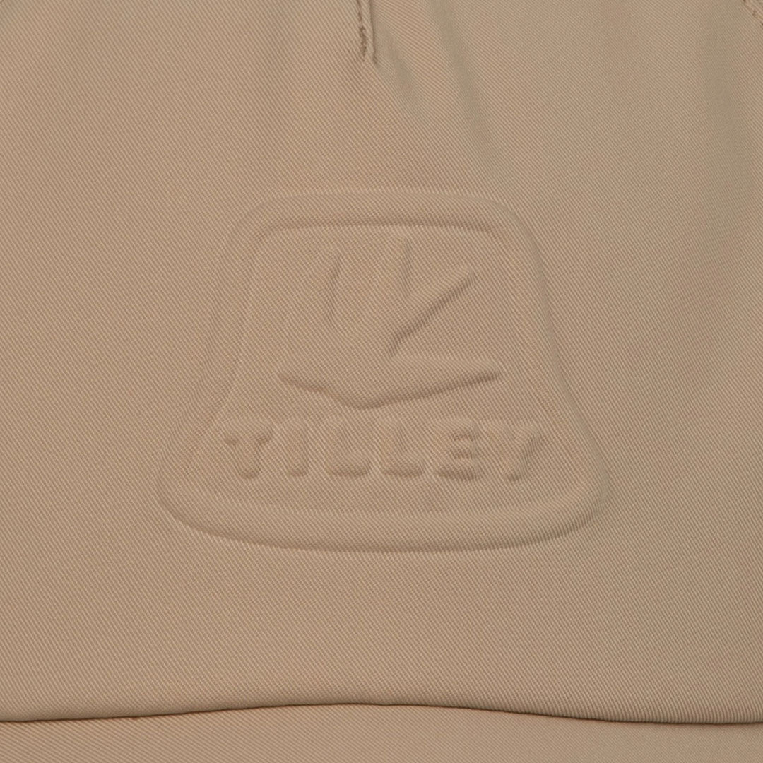 Beige fabric with embossed logo on Tilley Tech Travel Cap for stylish adventures