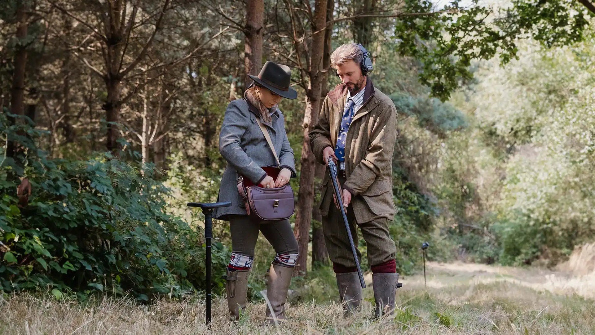 Two people hunting in the woods.