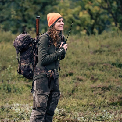 Hunter in camouflage gear wearing Woolpower Unisex Zip Turtleneck in the outdoors