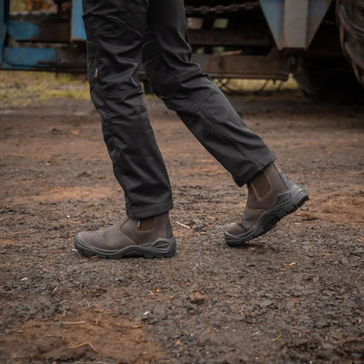 Brown leather Xpert Defiant S3 Safety Dealer Boot on feet with black soles