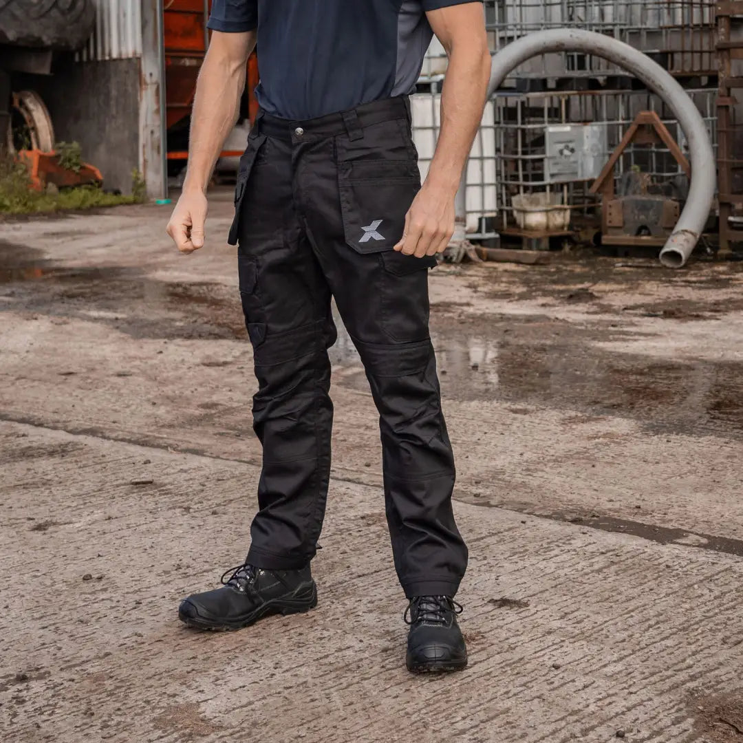Black work trouser and safety boots worn by a person in Xpert Pro Stretch+ Work Trouser for country clothing or hunting