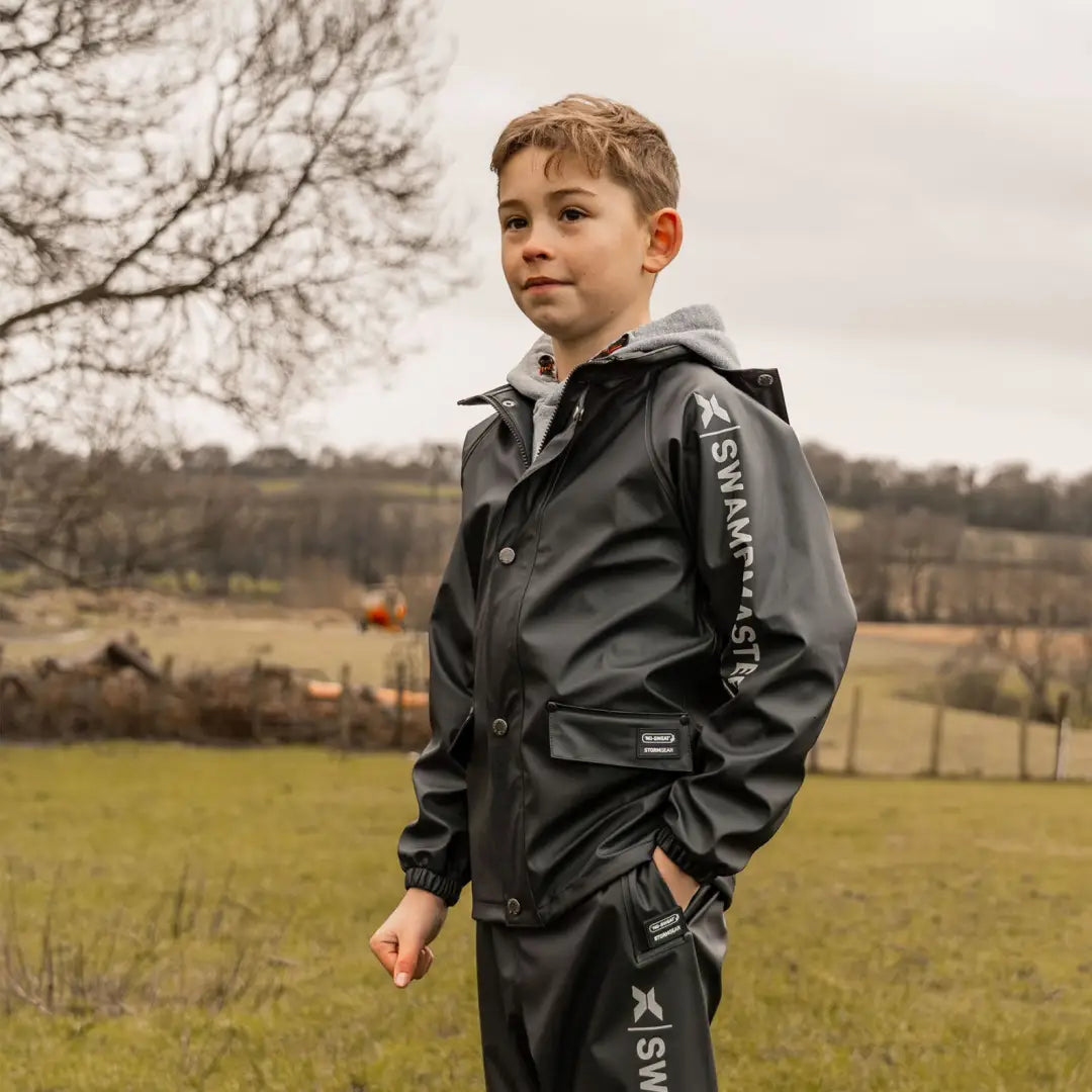 Child wearing Xpert Swampmaster Stormgear Junior Waterproof Jacket and trousers outdoors